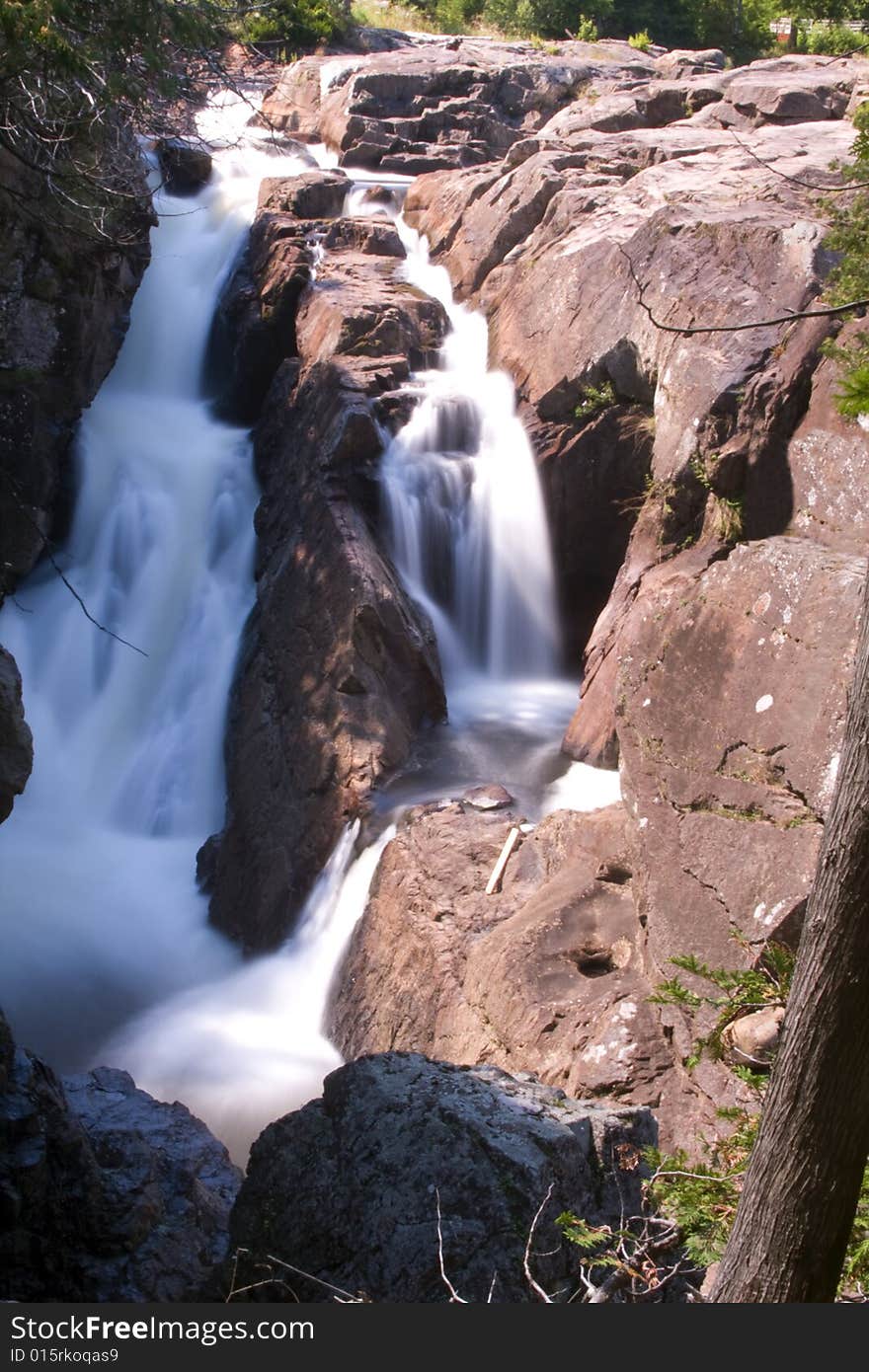 A waterfall crashes through several steps on its journey to the sea. A waterfall crashes through several steps on its journey to the sea.