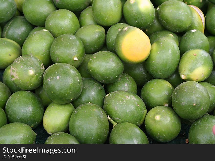 Stack of limes at a produce market.
