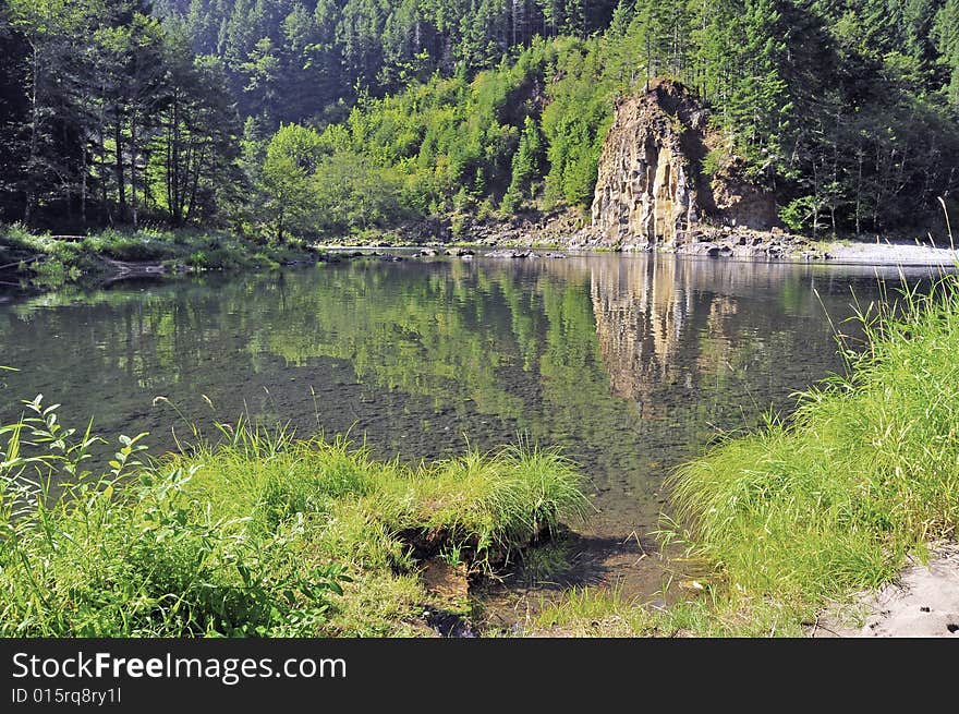 Rock's reflection in the creek of the mountain