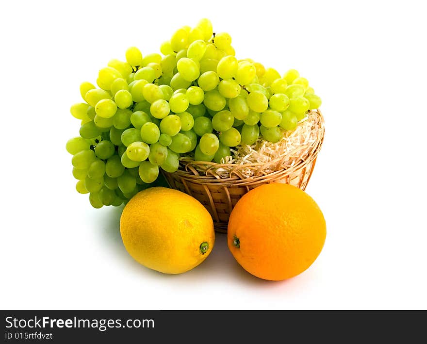 Basket with green grapes and citruses