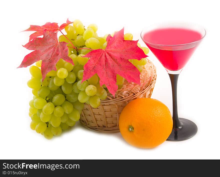 Grapes and tasty ripe orange with yellow basket on white background