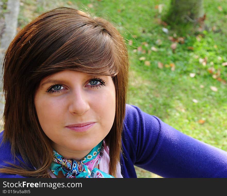 Pretty young woman sitting outside enjoying the weather. Pretty young woman sitting outside enjoying the weather