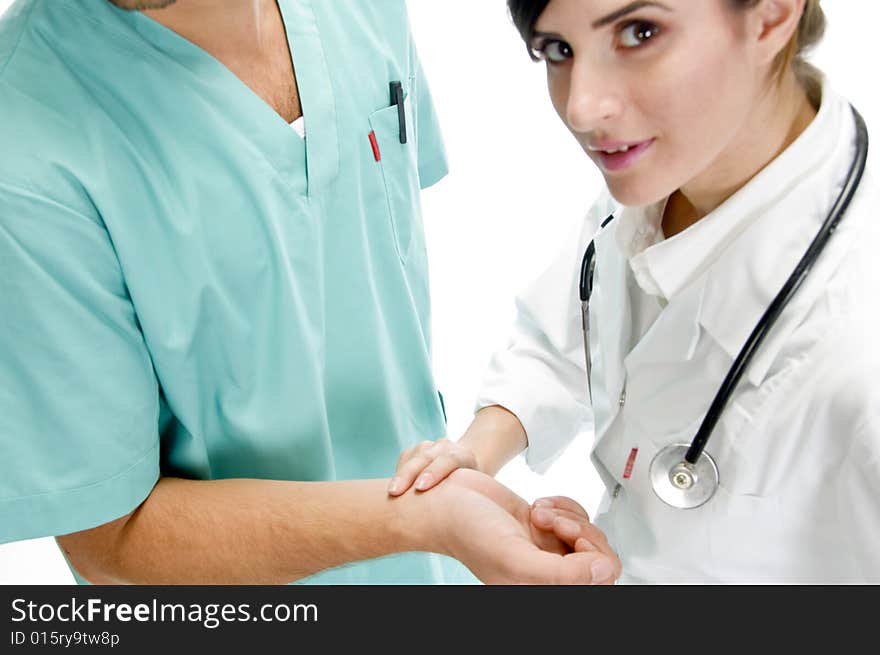 Young nurse checking pulse of patient with white background