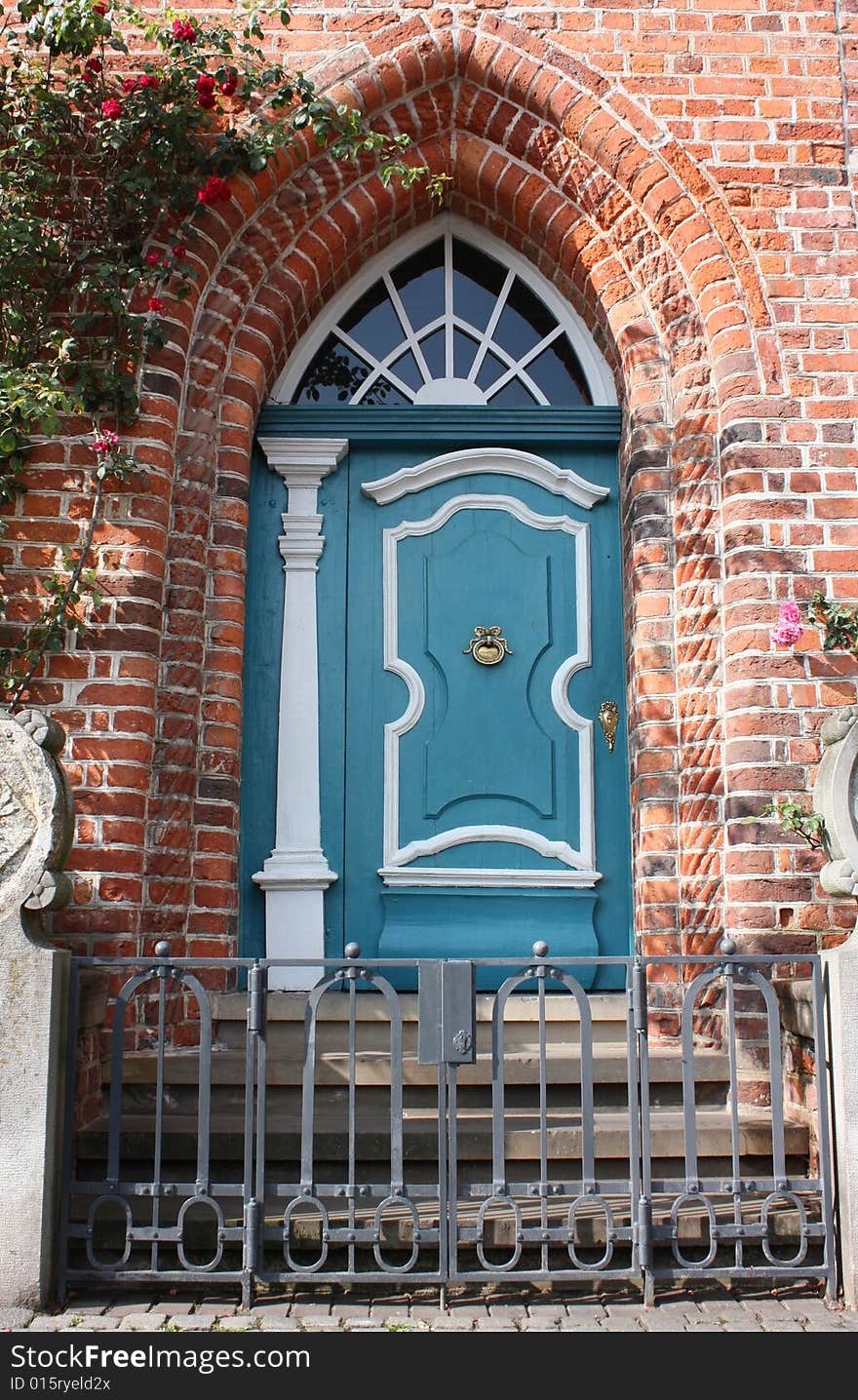 Old romantic blue door with metallic fence