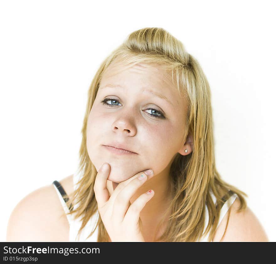 Young teenage girl looking at the camera with a thoughtful expression. Isolated on white background. See my portfolio for other expressions in this series. Young teenage girl looking at the camera with a thoughtful expression. Isolated on white background. See my portfolio for other expressions in this series.