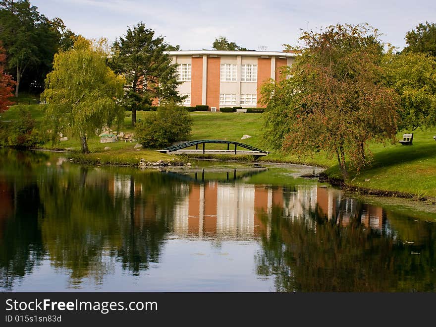 Building reflected in pond in Beverly, Massachusetts. Early fall when the trees are beginning to change colors. Building reflected in pond in Beverly, Massachusetts. Early fall when the trees are beginning to change colors.