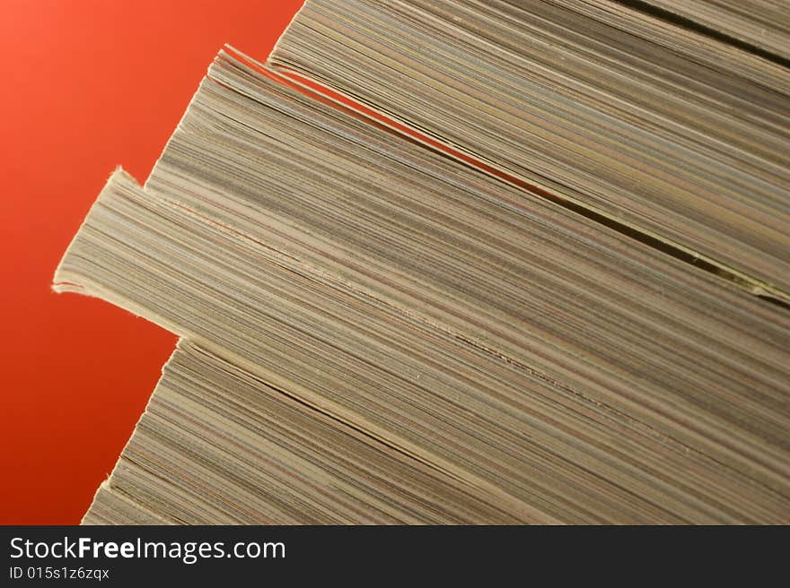 A close up frame with magazines in a red background. A close up frame with magazines in a red background