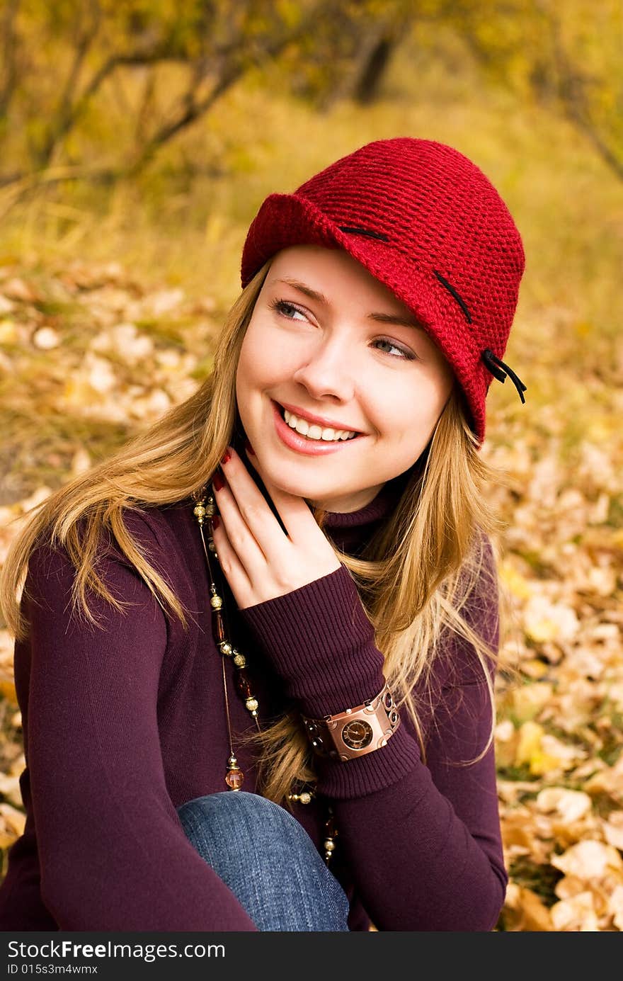 Pretty girl wearing a red hat in the park. Pretty girl wearing a red hat in the park