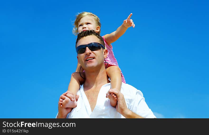 View of young family hanging out in summer environment. View of young family hanging out in summer environment.