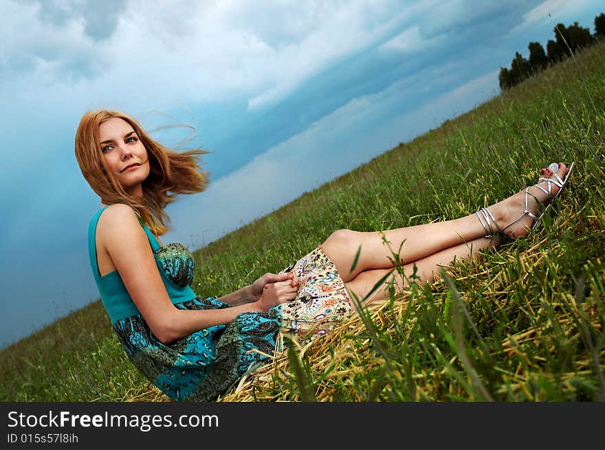 Pretty girl sitting in autumn field. Pretty girl sitting in autumn field