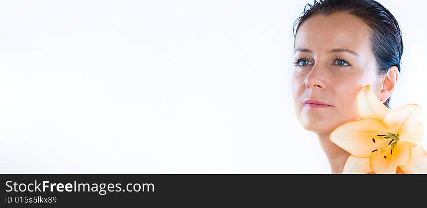 High key portrait of nice brunette with big lily flower. Banner, lots of copy space. High key portrait of nice brunette with big lily flower. Banner, lots of copy space