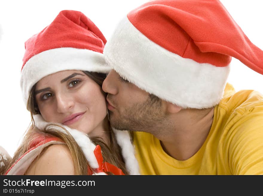 Young male kissing female against white background