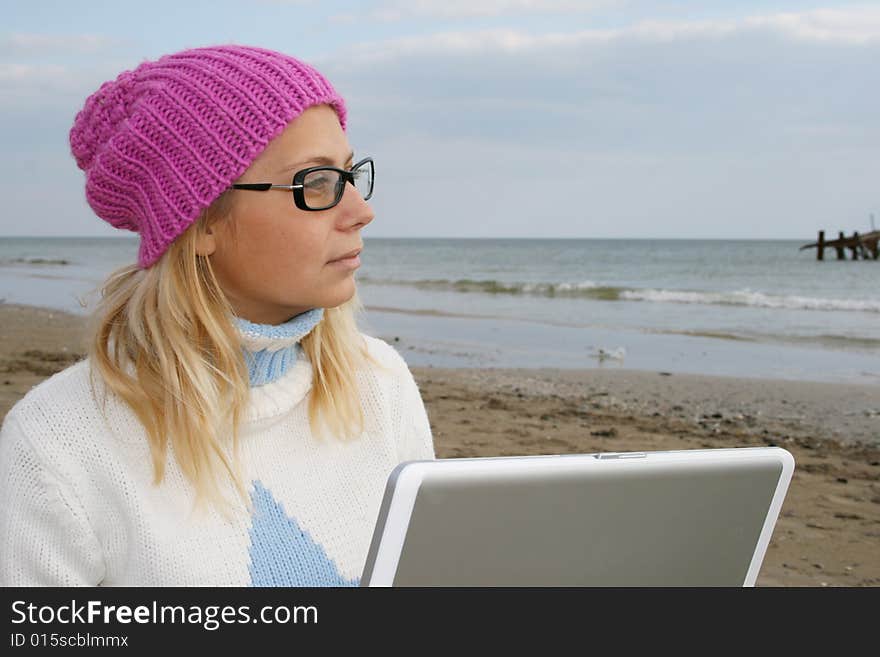 Girl on a beach with a notebook