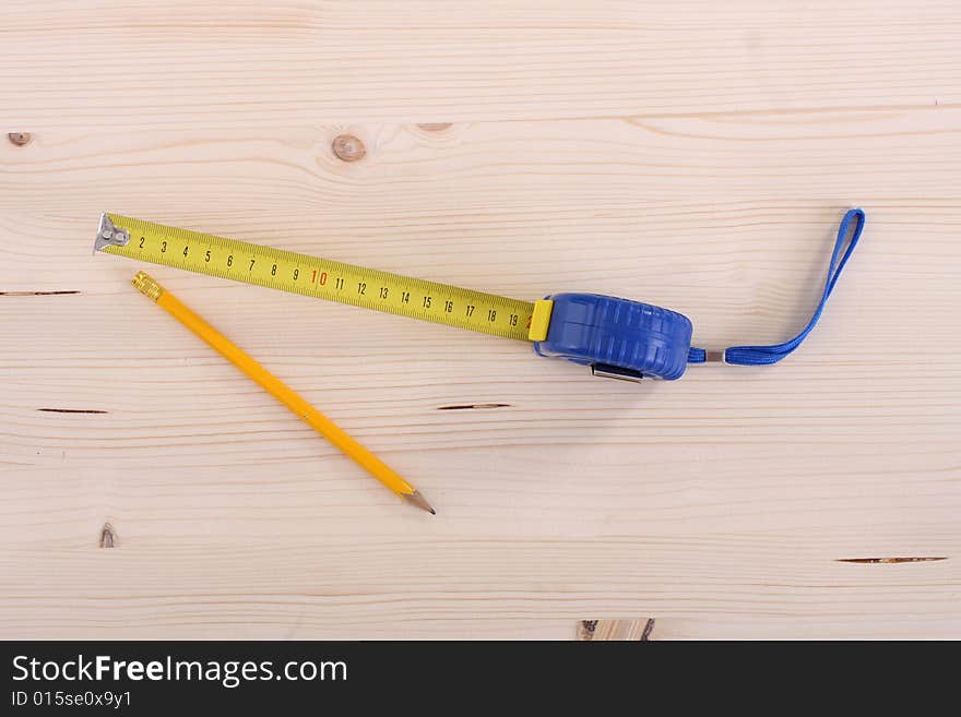 Closeup shot of wooden plank and measuring tape