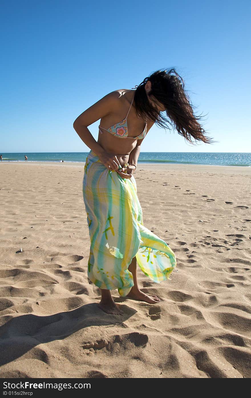 Woman with beach wrap at el palmar beach in cadiz spain