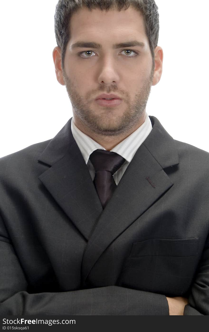 Businessman with folded hands looking to camera on an isolated white background