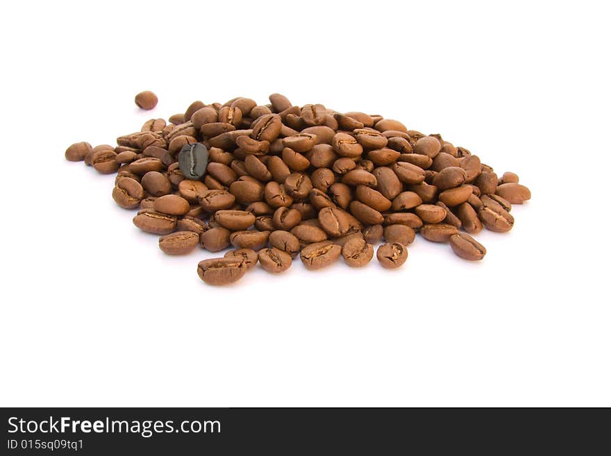 Lots of brown coffee beans and one of different color. Lots of brown coffee beans and one of different color