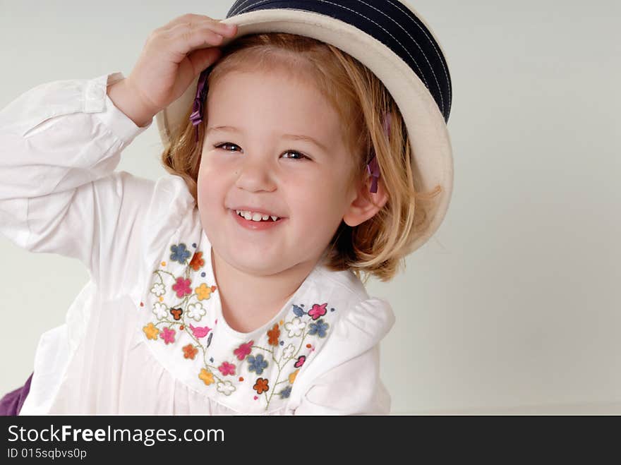 Cute little two year old girl playing with hat. Cute little two year old girl playing with hat