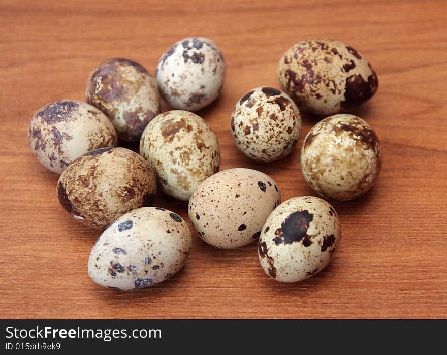 Quail eggs on a wooden surface