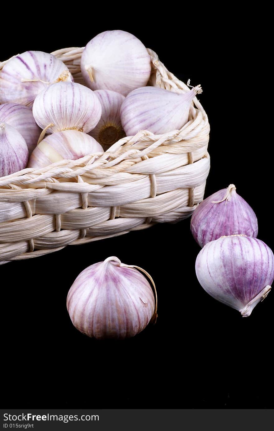 Wonderful garlic in little basket isolated on black. Wonderful garlic in little basket isolated on black.