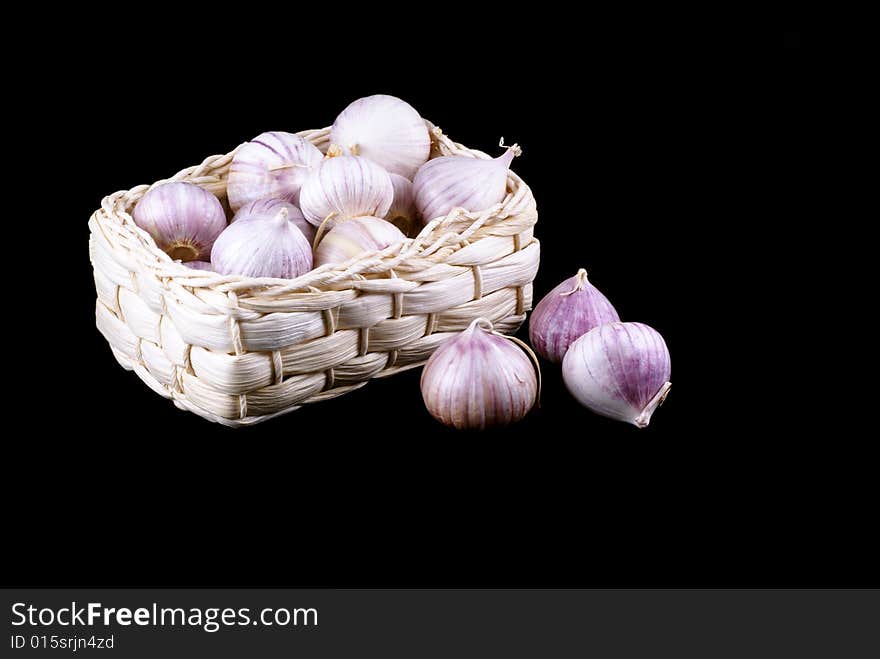 Basket full of garlic isolated on a black background. Basket full of garlic isolated on a black background.