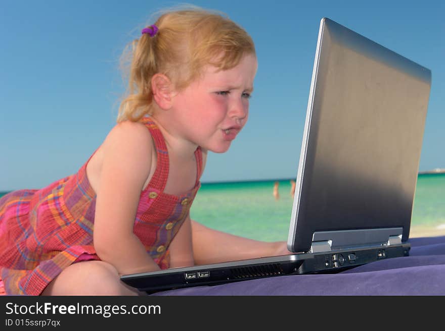 Girl with computer on a background of the sea