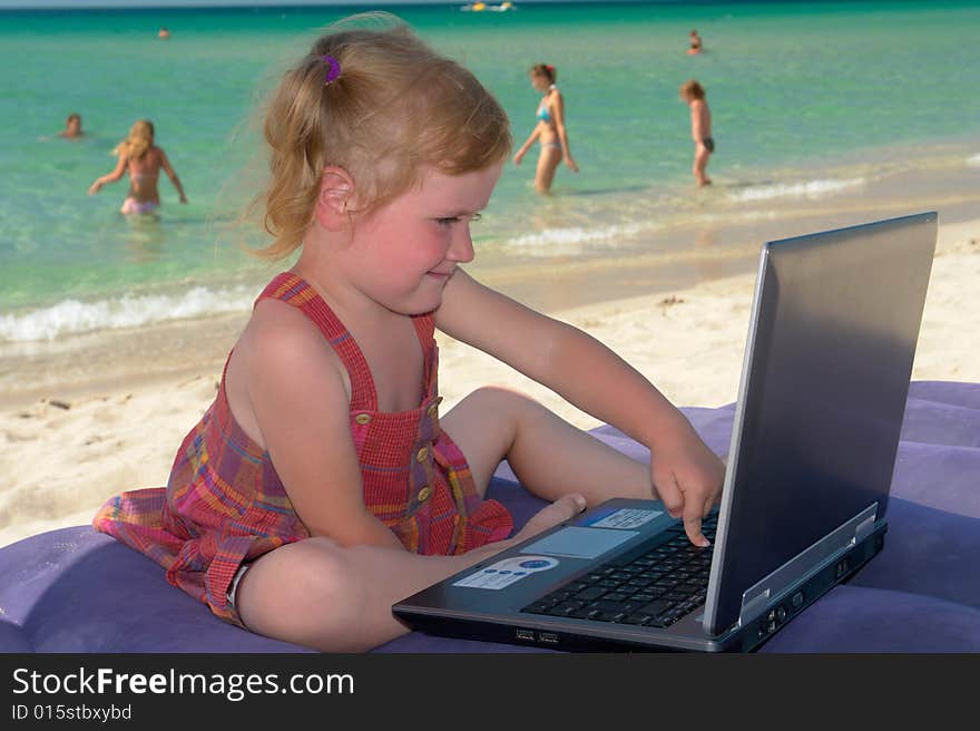 Girl with computer on a background of the sea