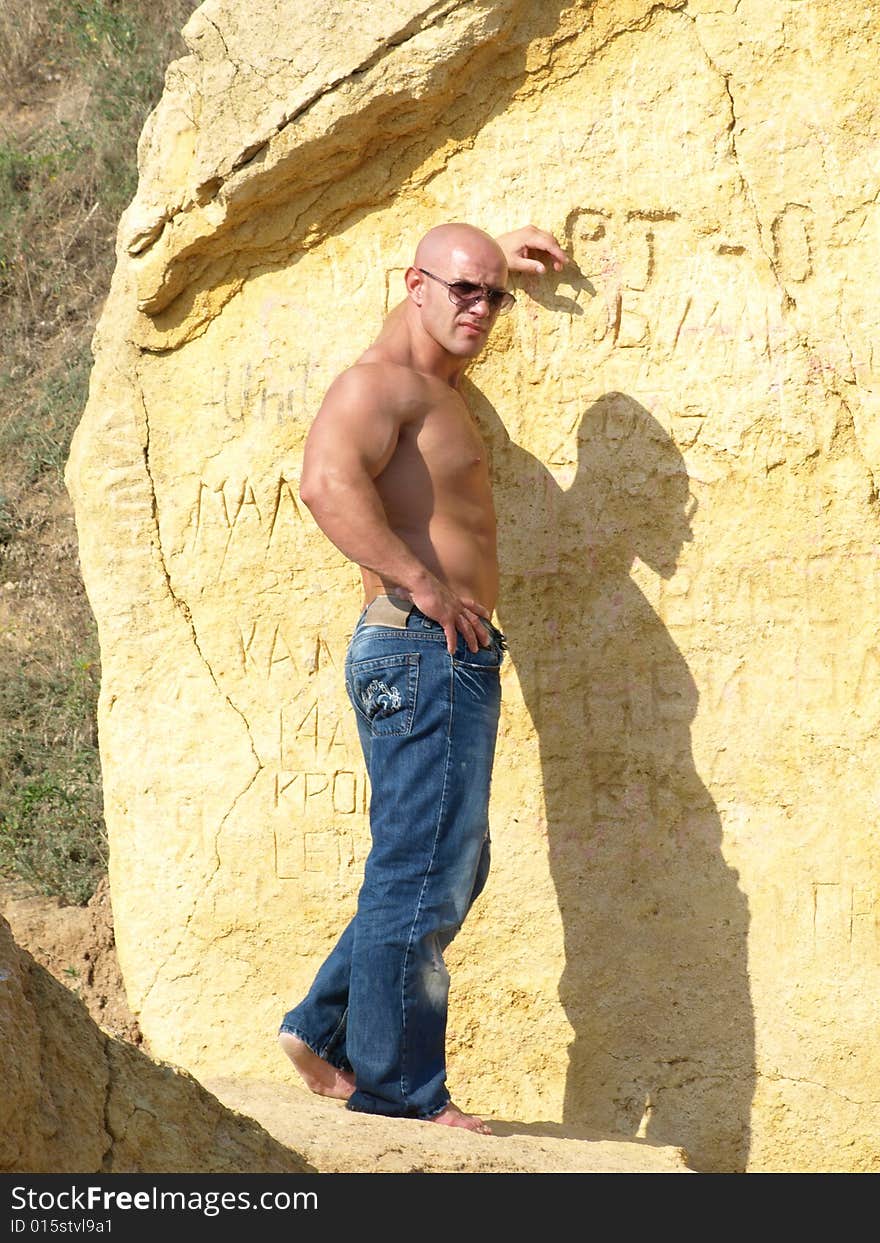 Strong bald man with nude torso