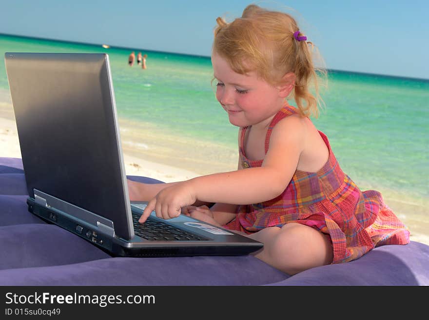 Girl with computer on a background of the sea