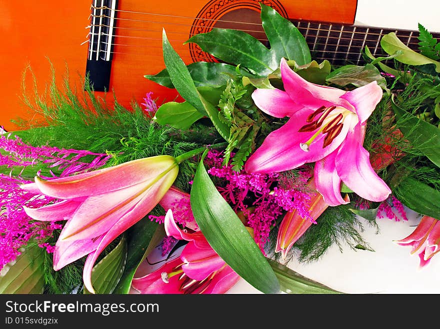 Pink lily and guitar composition over white. Pink lily and guitar composition over white