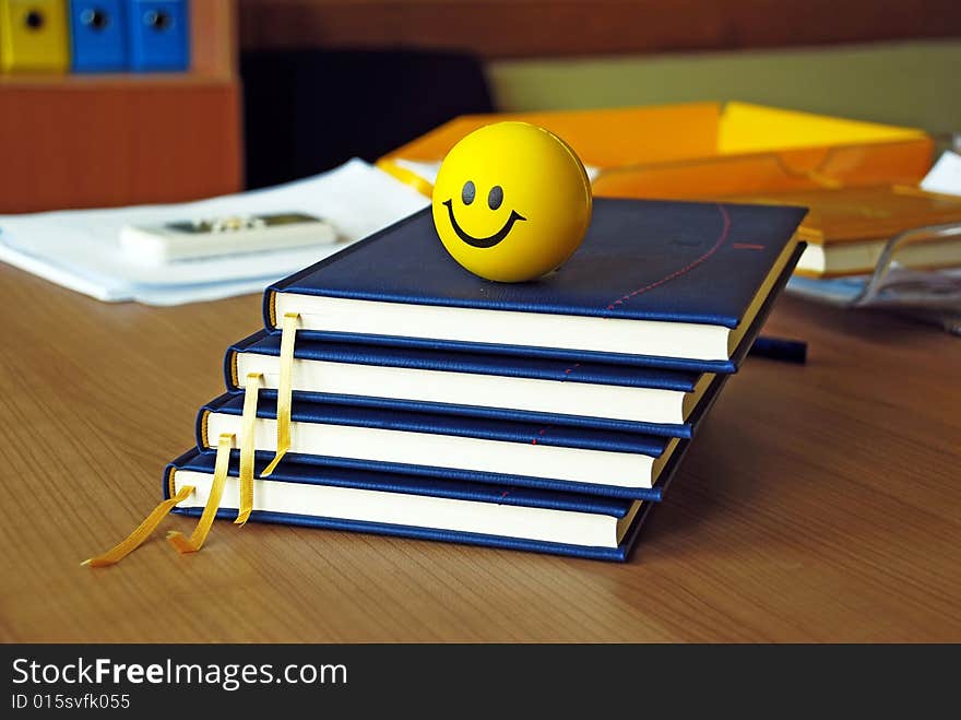 New blue organizers and yellow smiley ball on office desk. New blue organizers and yellow smiley ball on office desk