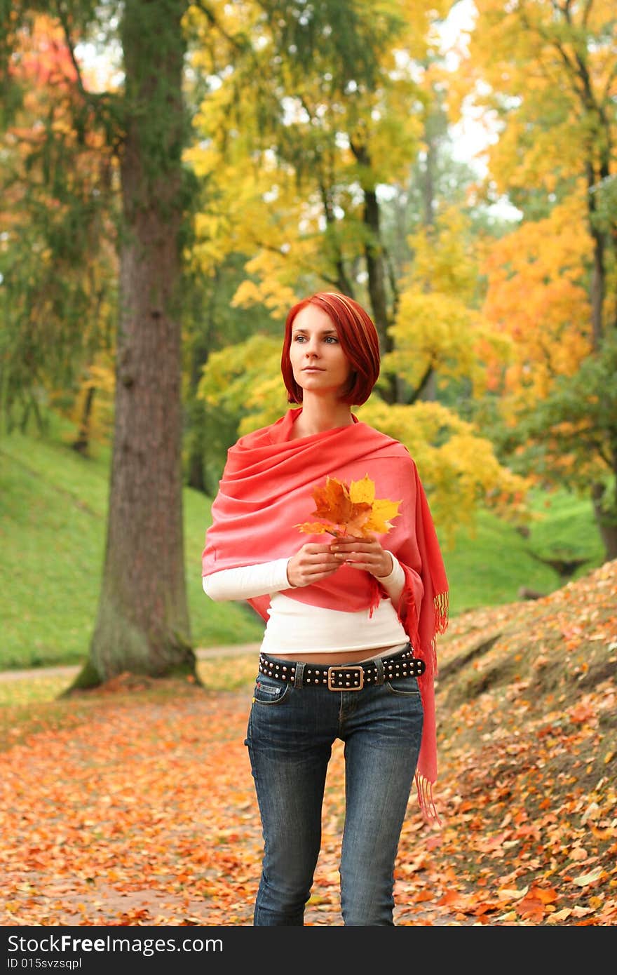 Young girl walking in autumn park