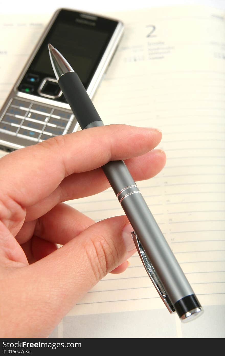 Hand With Pen And Notepad