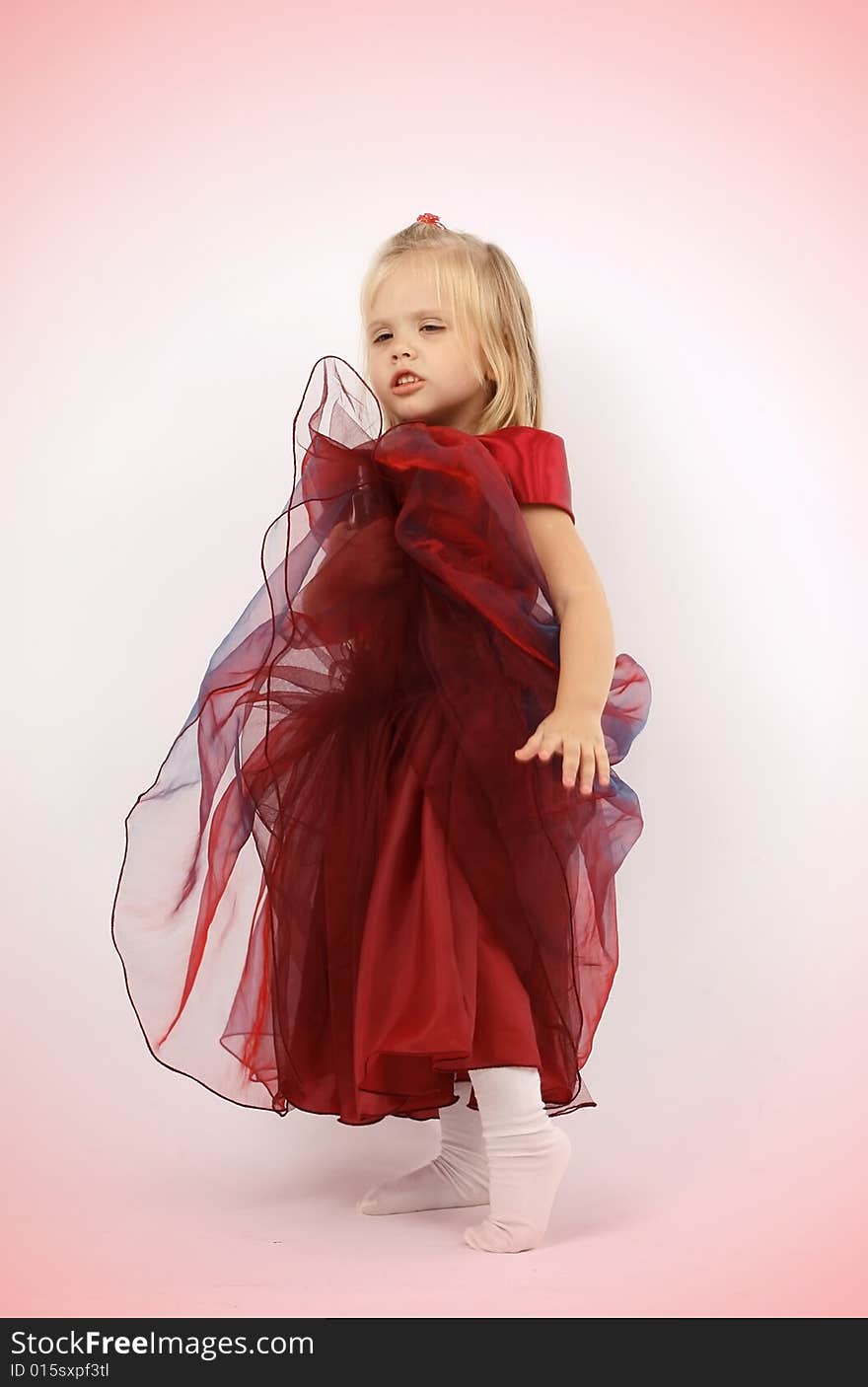 Portrait of the beautiful girl in a red dress