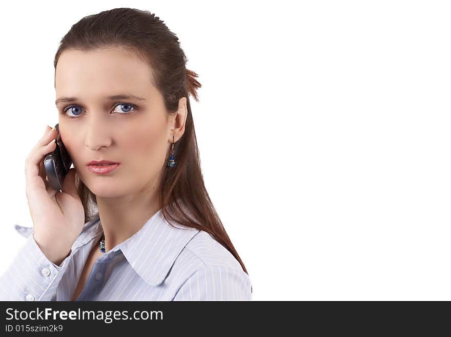 Beautiful brunette businesswoman wearing a blue shirt, talking on the phone. Isolated on white background with copy space