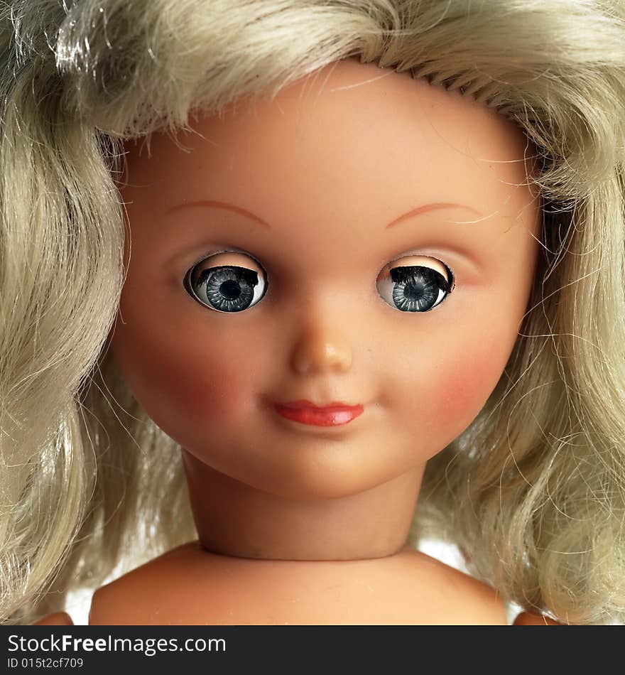 Portrait of a plastic doll  isolated on white