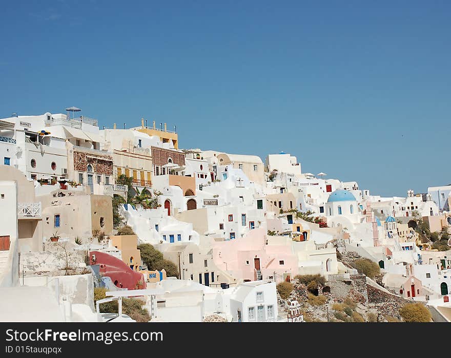 Brightly painted houses, villas and hotels perched on the edge of the cliff on the Greek island of Santorini. Brightly painted houses, villas and hotels perched on the edge of the cliff on the Greek island of Santorini.