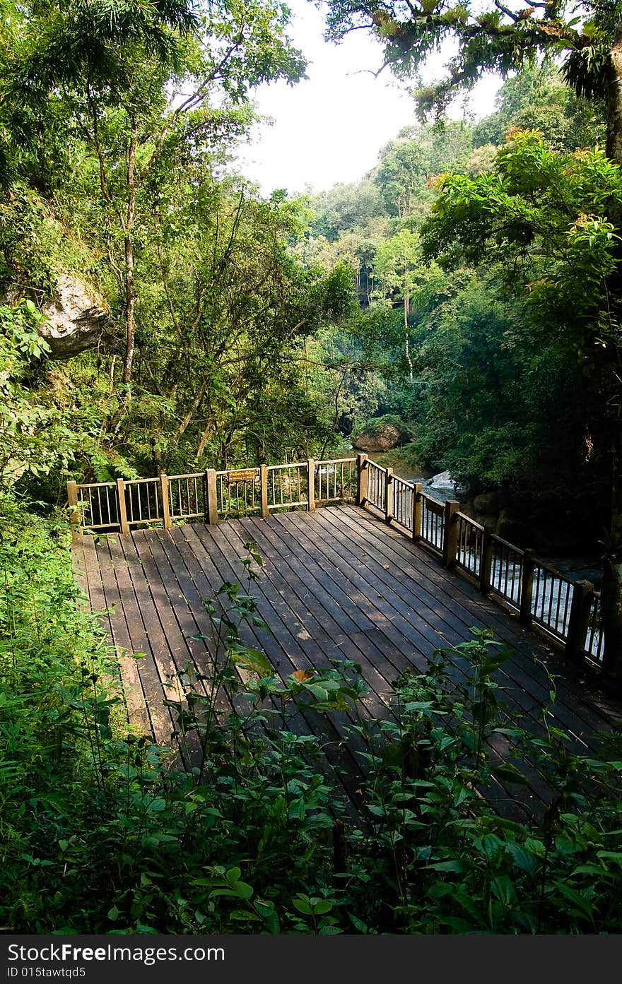 A wooden terrace standing on top of a river. A wooden terrace standing on top of a river.