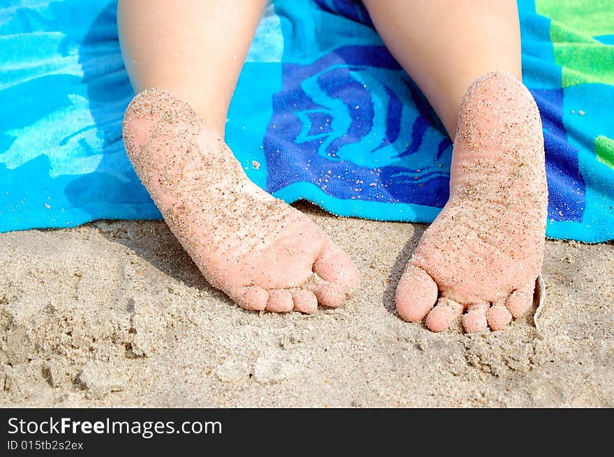 Sandy toes take a rest at the beach. Sandy toes take a rest at the beach