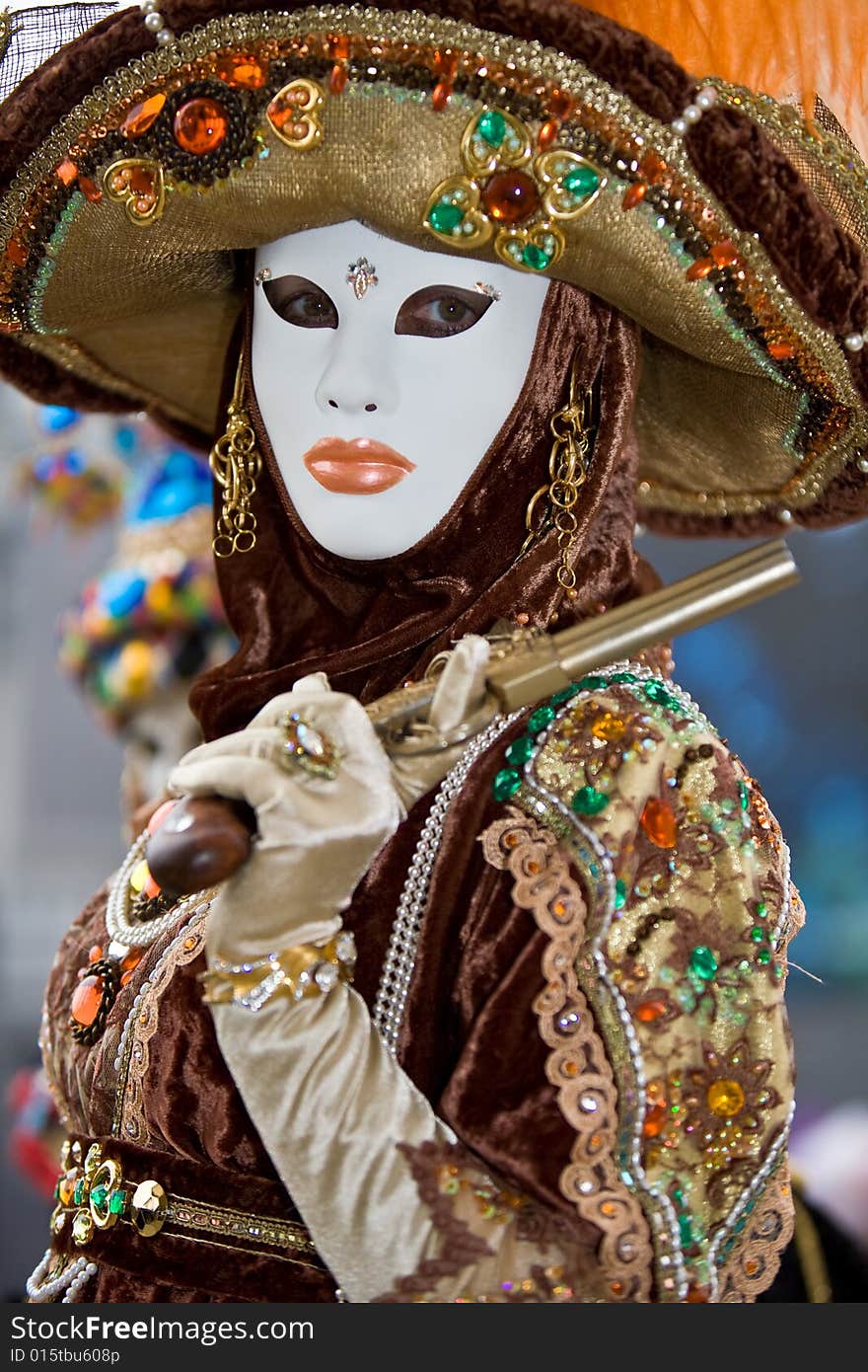 A person in costume holding a pistol at the Venice Carnival. A person in costume holding a pistol at the Venice Carnival