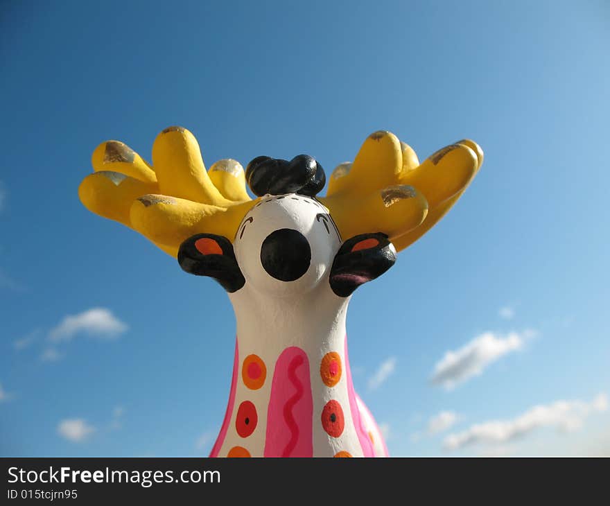 The golden antlers stag from fire-clay on the blue sky background. Hand made Dymka-toy. Russian national traditional toy from Vyatka town.
. The golden antlers stag from fire-clay on the blue sky background. Hand made Dymka-toy. Russian national traditional toy from Vyatka town.