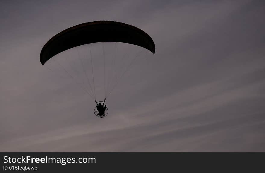 Paraglider Flight on dark cloudy