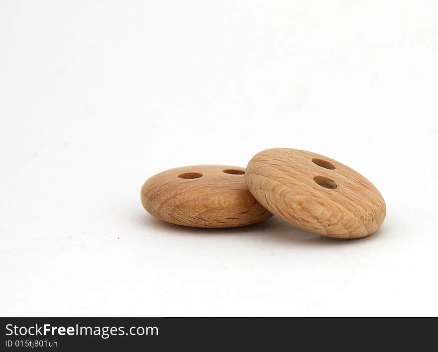 Two wooden buttons on white background