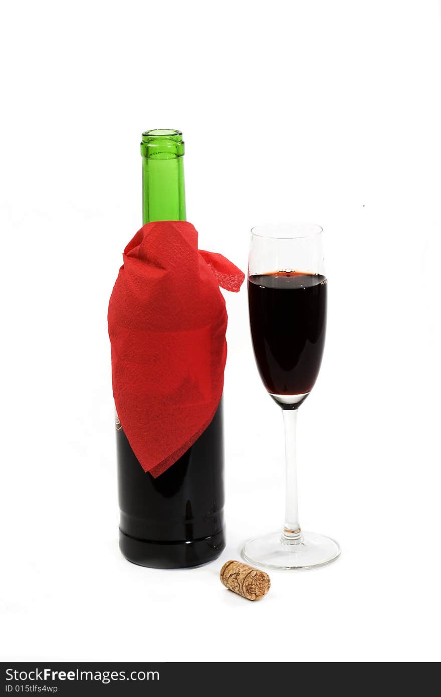 A green bottle of red wine and crystalline tall wineglass. A green bottle of red wine and crystalline tall wineglass