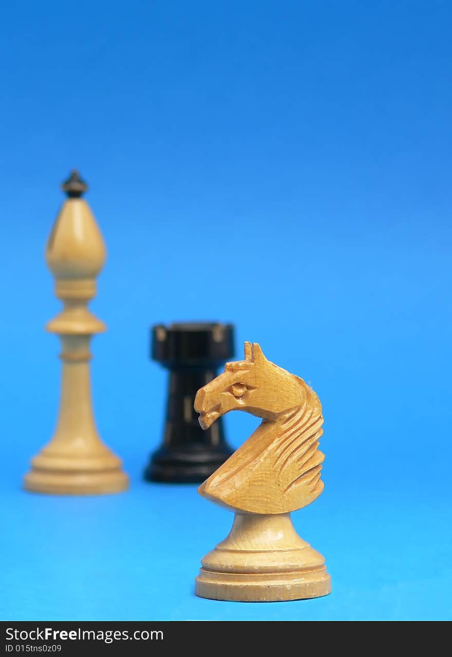 Black and white chess figures on blue background