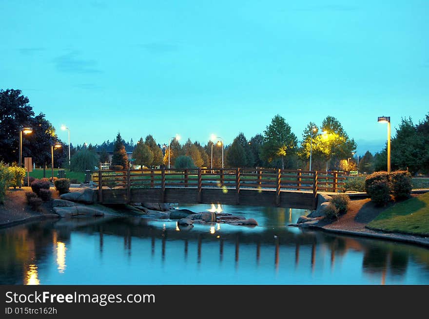 Bridge in the park at night with evening lights