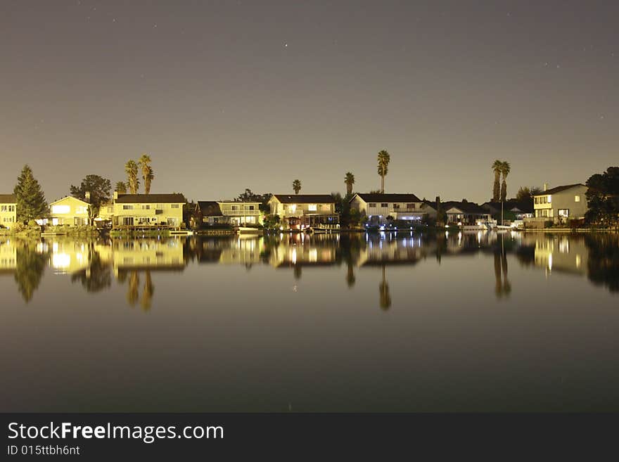 Moonlit reflection of waterfront vacation homes. Moonlit reflection of waterfront vacation homes.