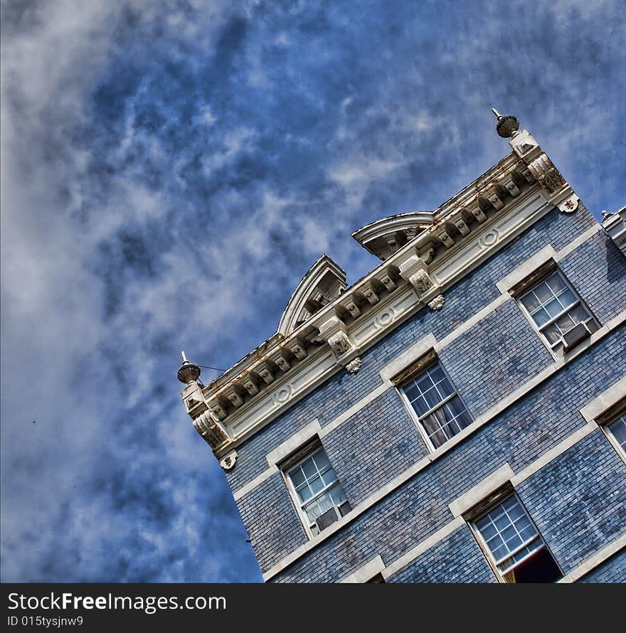 View of classic, historical blue building against a blue sky. View of classic, historical blue building against a blue sky.