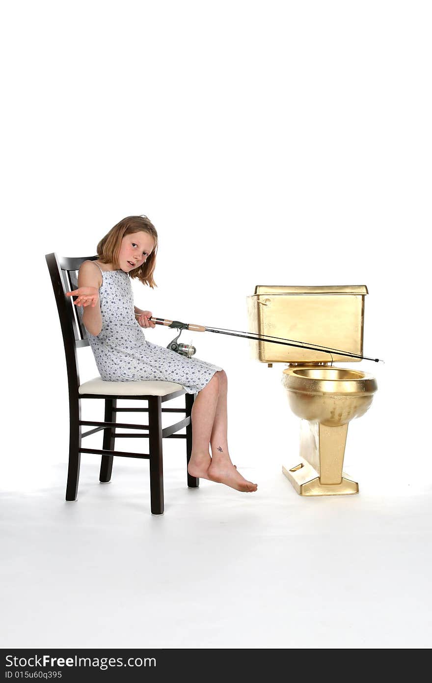 Girl sitting in chair and fishing in gold toilet. Girl sitting in chair and fishing in gold toilet