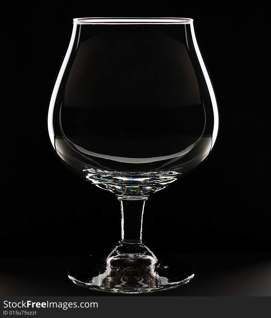 Empty glass against black background